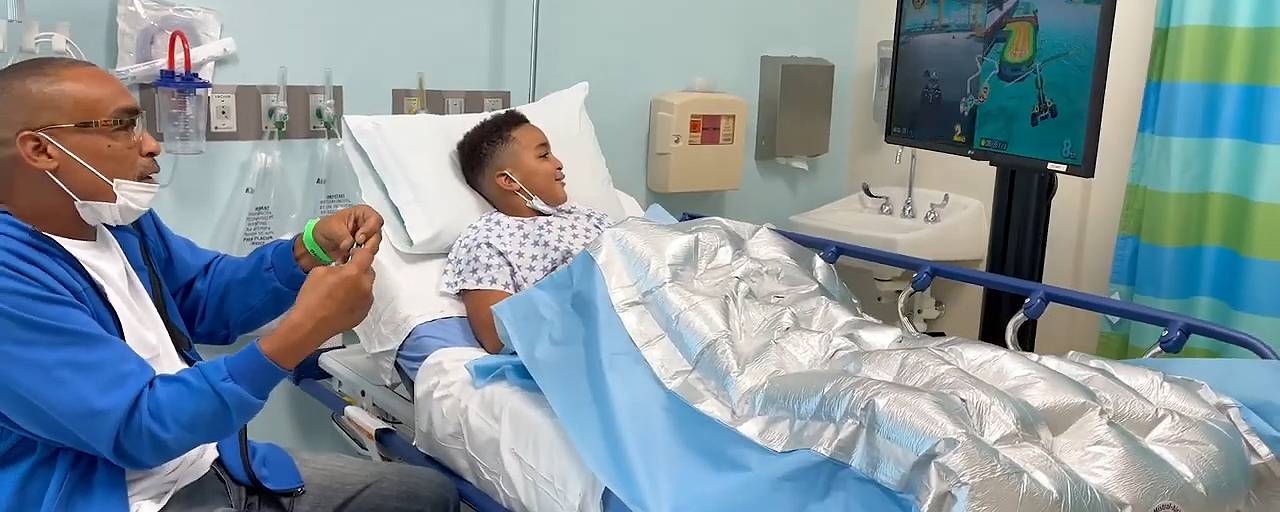 Two kids in hospital gaming room playing together