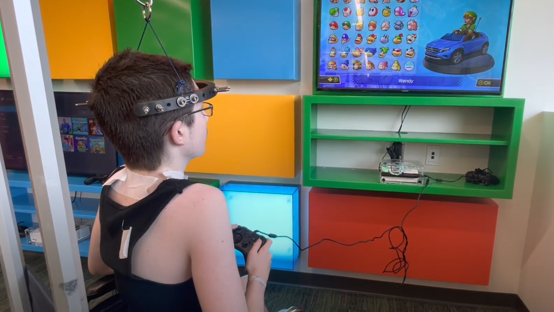 Teenager with medical device playing Mario Kart